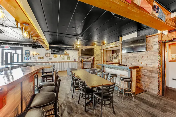 a dining room with furniture and a kitchen view
