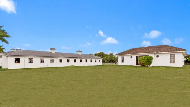 a view of a house with a swimming pool and a yard