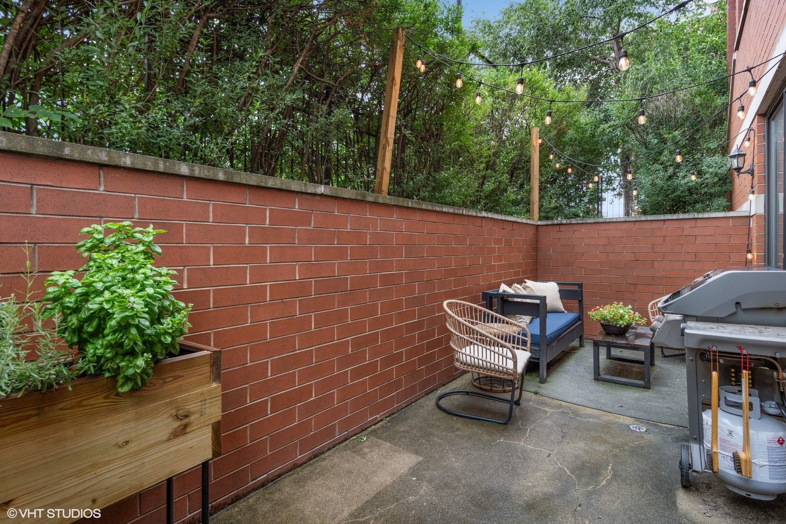 958 North Wood Street, Unit A Chicago, IL 60622 - Photo 16 of 17 a view of a patio with table and chairs with wooden fence and plants