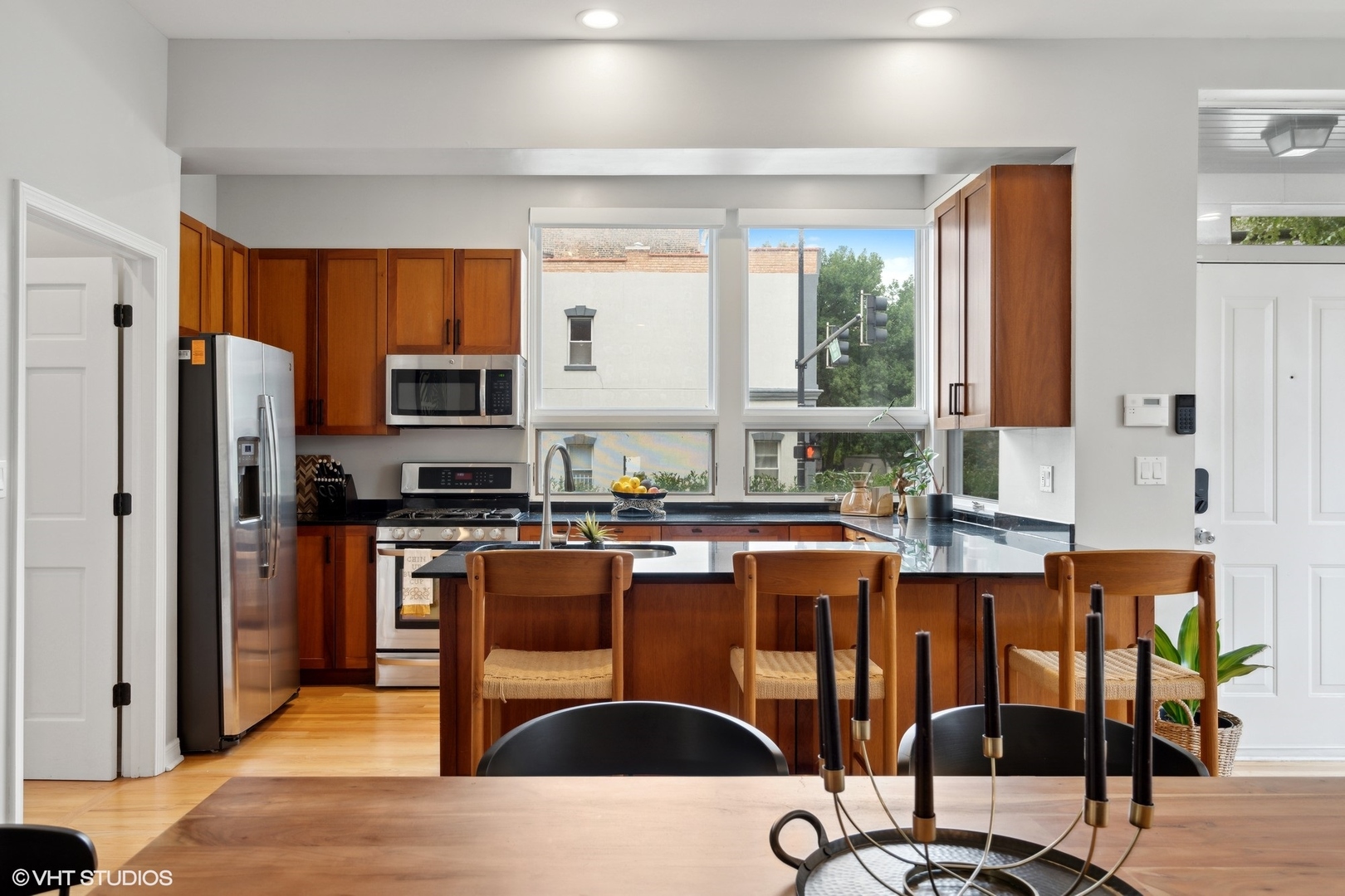 958 North Wood Street, Unit A Chicago, IL 60622 - Photo 3 of 17 a kitchen with stainless steel appliances kitchen island granite countertop a refrigerator and a stove top oven