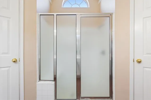 a bathroom with a glass shower door