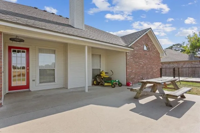 a front view of house with outdoor space and swimming pool