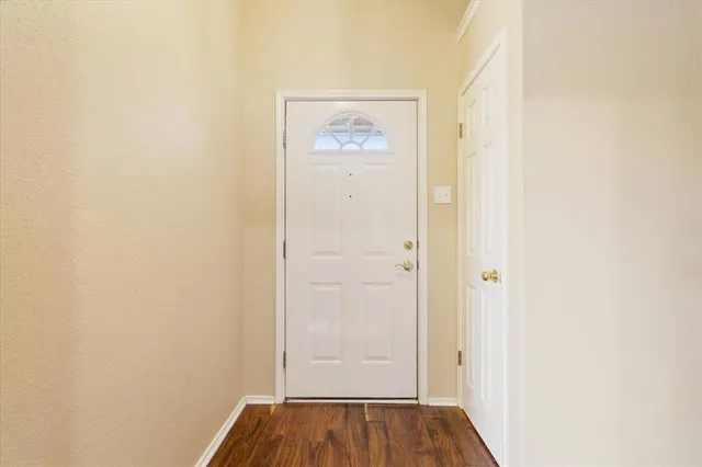 a view of hallway with wooden floor