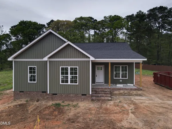 a view of a house with a yard and garage