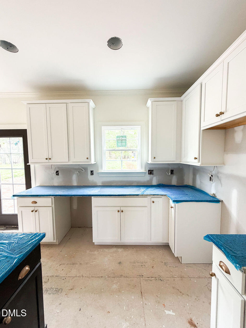 9574 Stallings Road Spring Hope, NC 27882 - Photo 16 of 31 a kitchen with granite countertop white cabinets white appliances with a sink and dishwasher