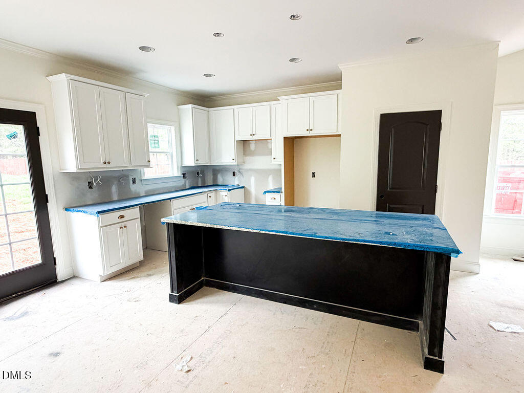 9574 Stallings Road Spring Hope, NC 27882 - Photo 17 of 31 a kitchen with granite countertop a stove a sink and a refrigerator