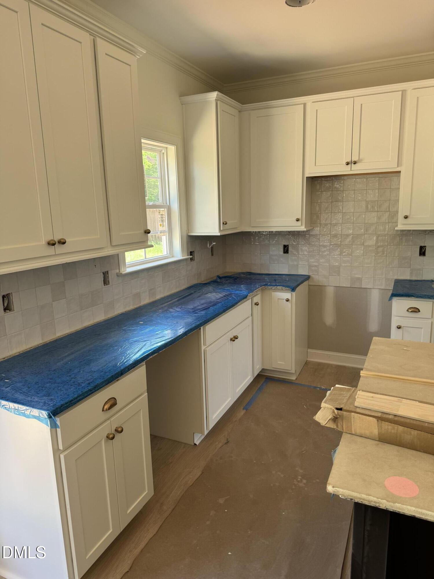 9574 Stallings Road Spring Hope, NC 27882 - Photo 29 of 31 a kitchen with granite countertop white cabinets and white appliances