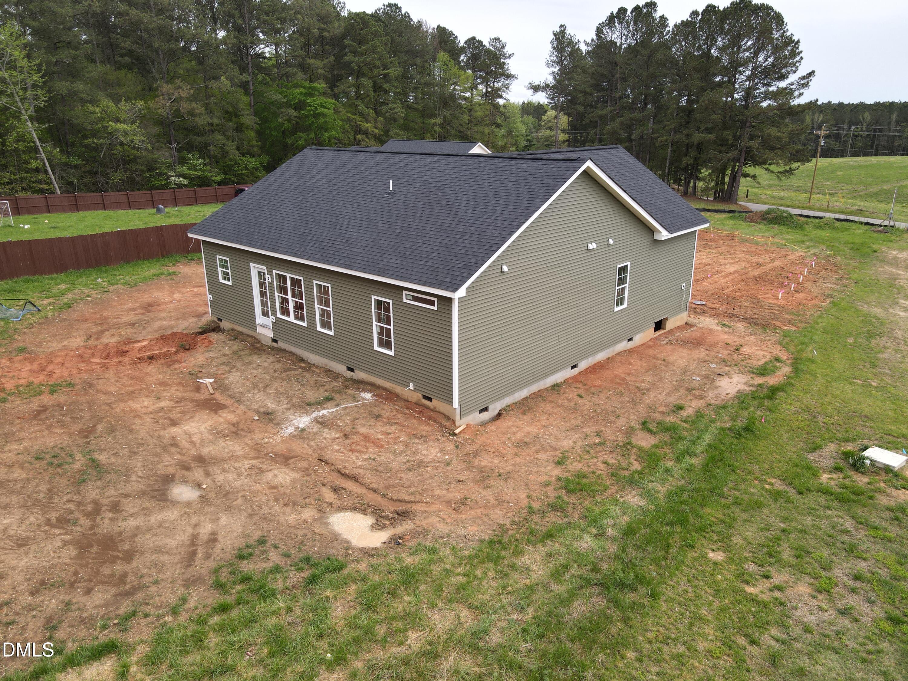 9574 Stallings Road Spring Hope, NC 27882 - Photo 4 of 31 a aerial view of a house next to a yard with large tree