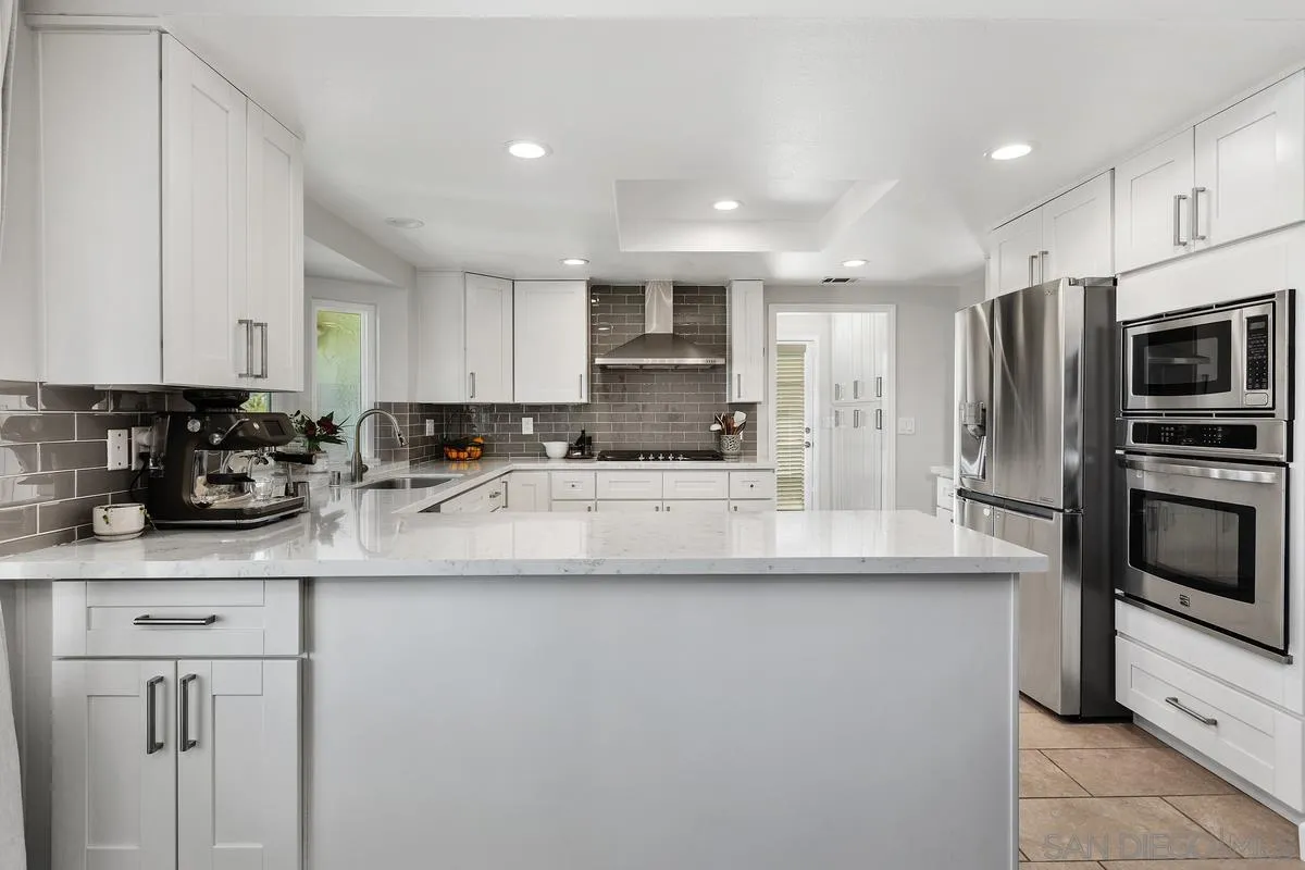 23969 Nectar Way Ramona, CA 92065 - Photo 18 of 54 a kitchen with stainless steel appliances granite countertop a sink a stove a refrigerator a microwave and cabinets