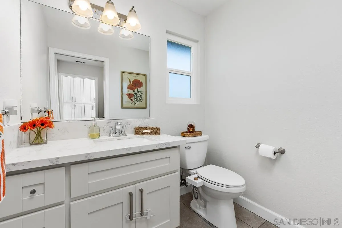 23969 Nectar Way Ramona, CA 92065 - Photo 23 of 54 a bathroom with a toilet a sink and mirror