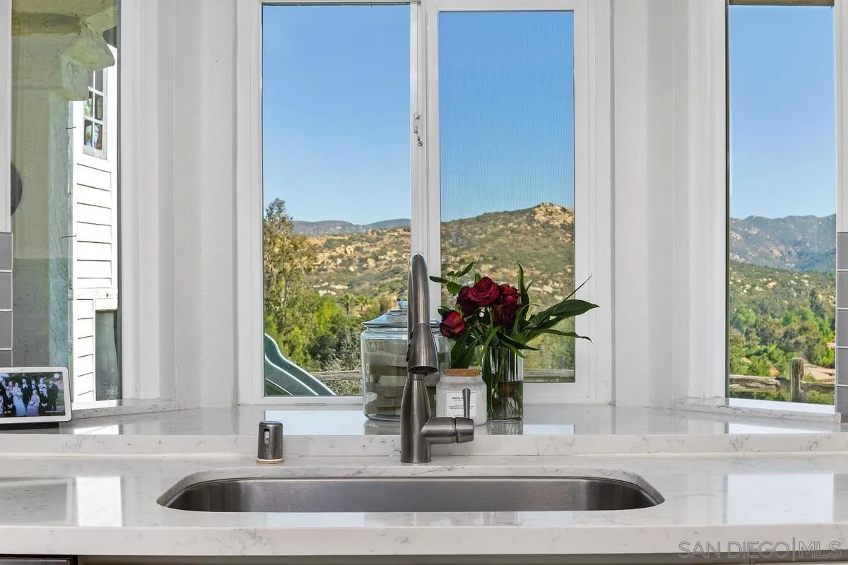 23969 Nectar Way Ramona, CA 92065 - Photo 3 of 54 a view of a sink a mirror and window in a room