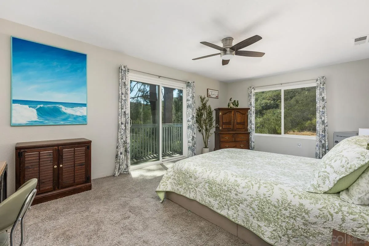 23969 Nectar Way Ramona, CA 92065 - Photo 39 of 54 a bedroom with a balcony a bed and a fireplace