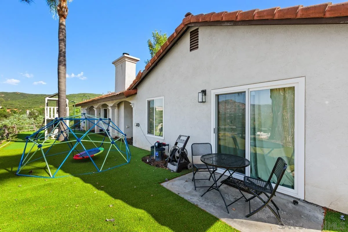 23969 Nectar Way Ramona, CA 92065 - Photo 7 of 54 a view of a patio with table and chairs under an umbrella
