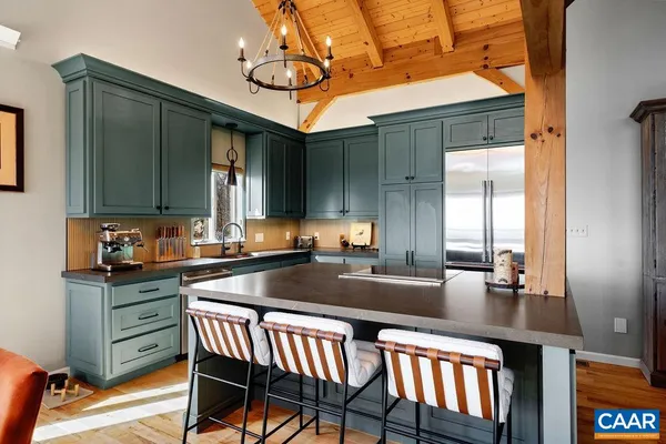a kitchen with stainless steel appliances granite countertop a sink stove and cabinets