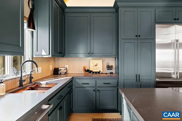 a kitchen with stainless steel appliances granite countertop a sink and cabinets