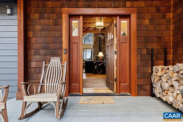 a living room with furniture a flat screen tv and a floor to ceiling window