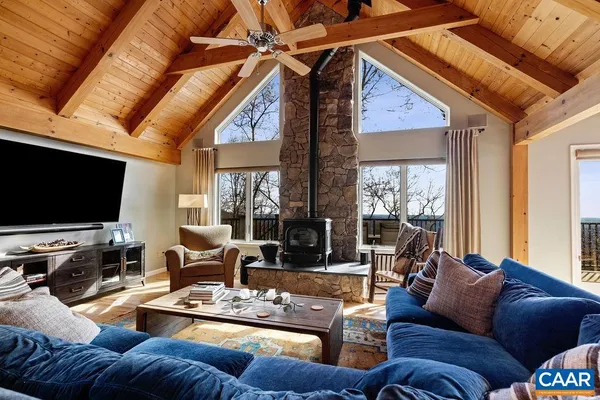 a living room with furniture fireplace and flat screen tv