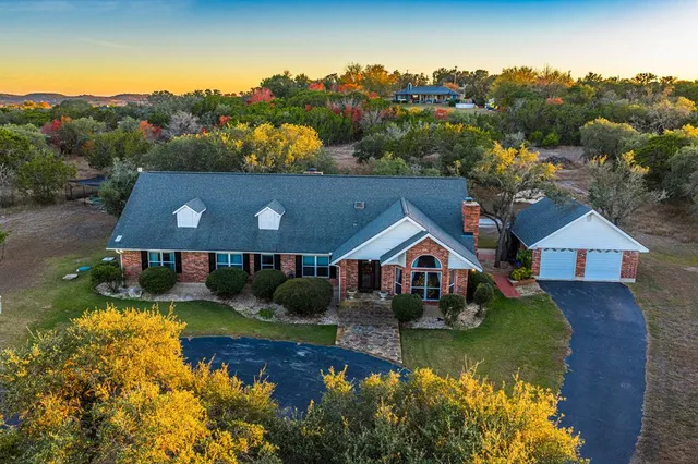 an aerial view of a house with a big yard
