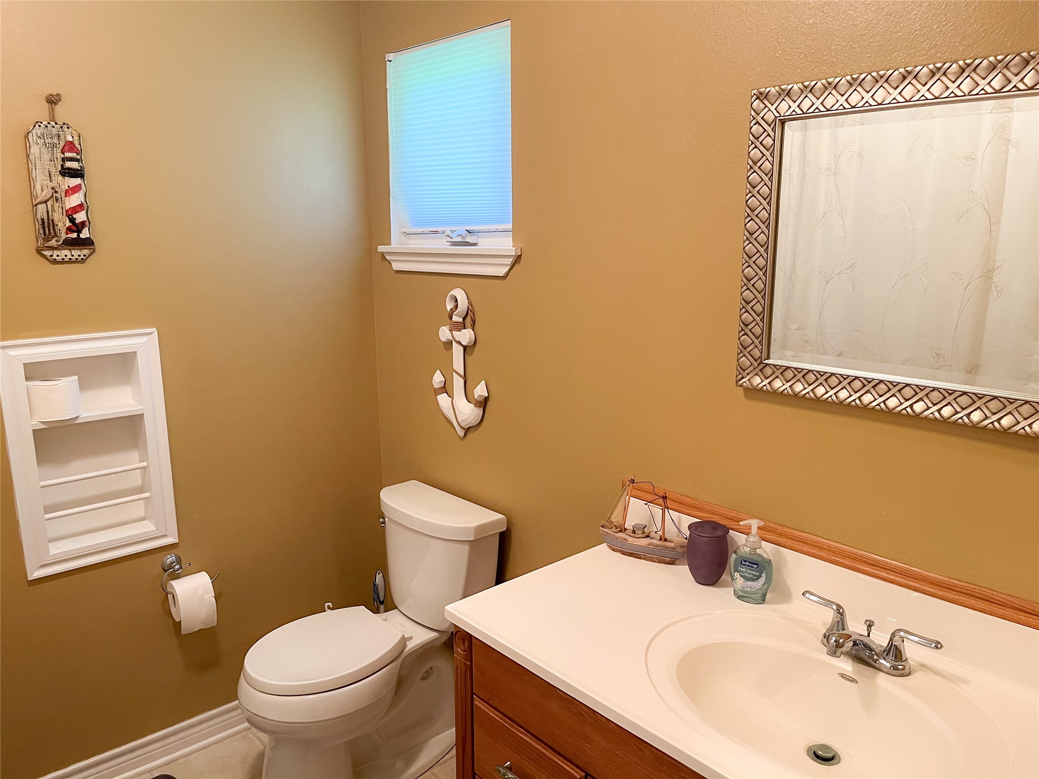 231 Memphis Belle Trinity, TX 75862 - Photo 33 of 47 a bathroom with a sink mirror and toilet
