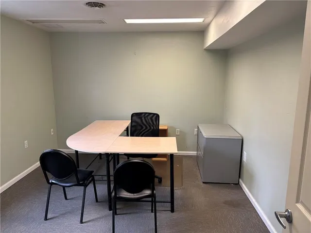 a view of a workspace with furniture