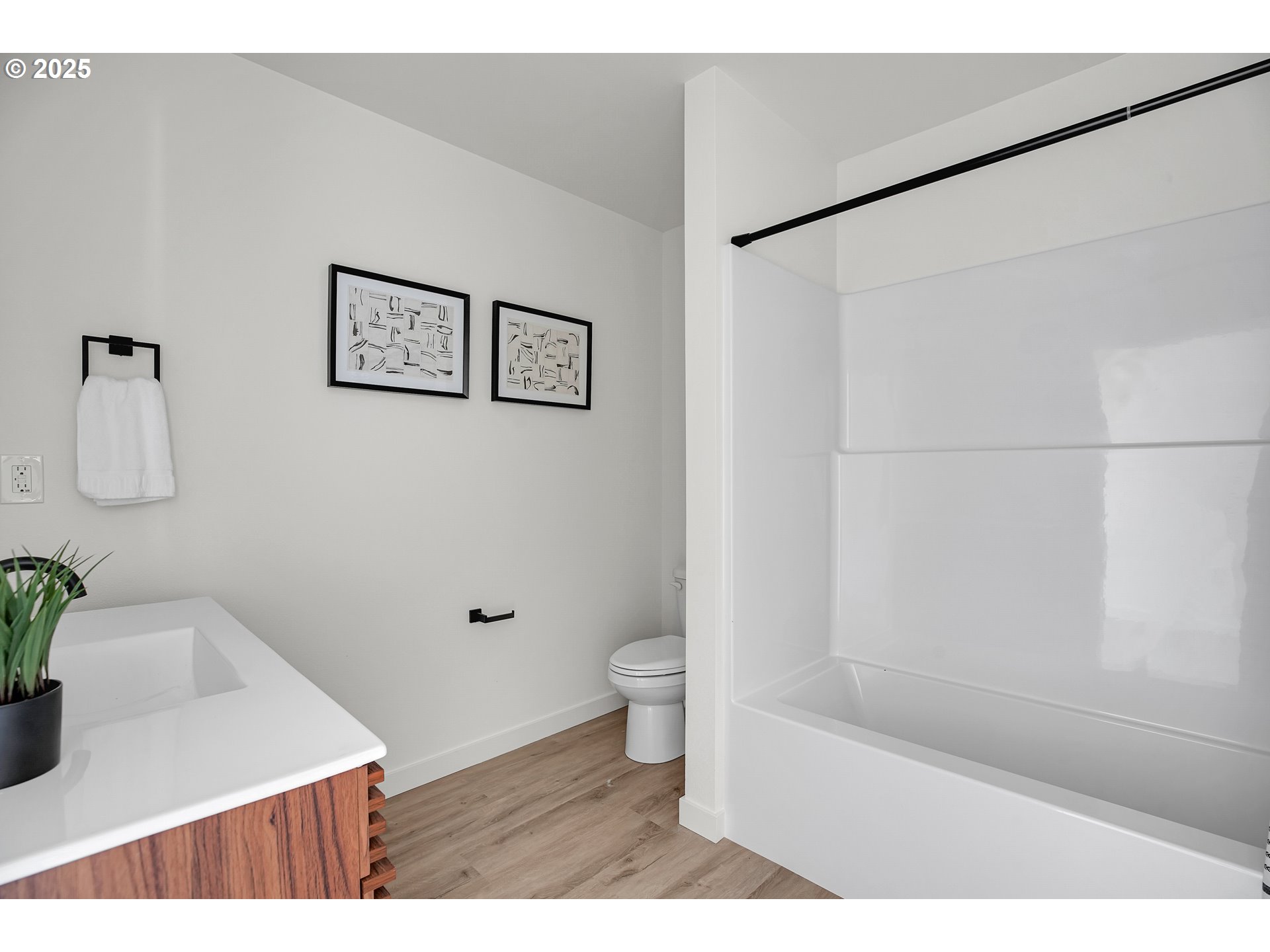 14852 Northeast Couch Street, Unit 9 Portland, OR 97230 - Photo 26 of 42 a bathroom with a bathtub shower sink vanity and toilet