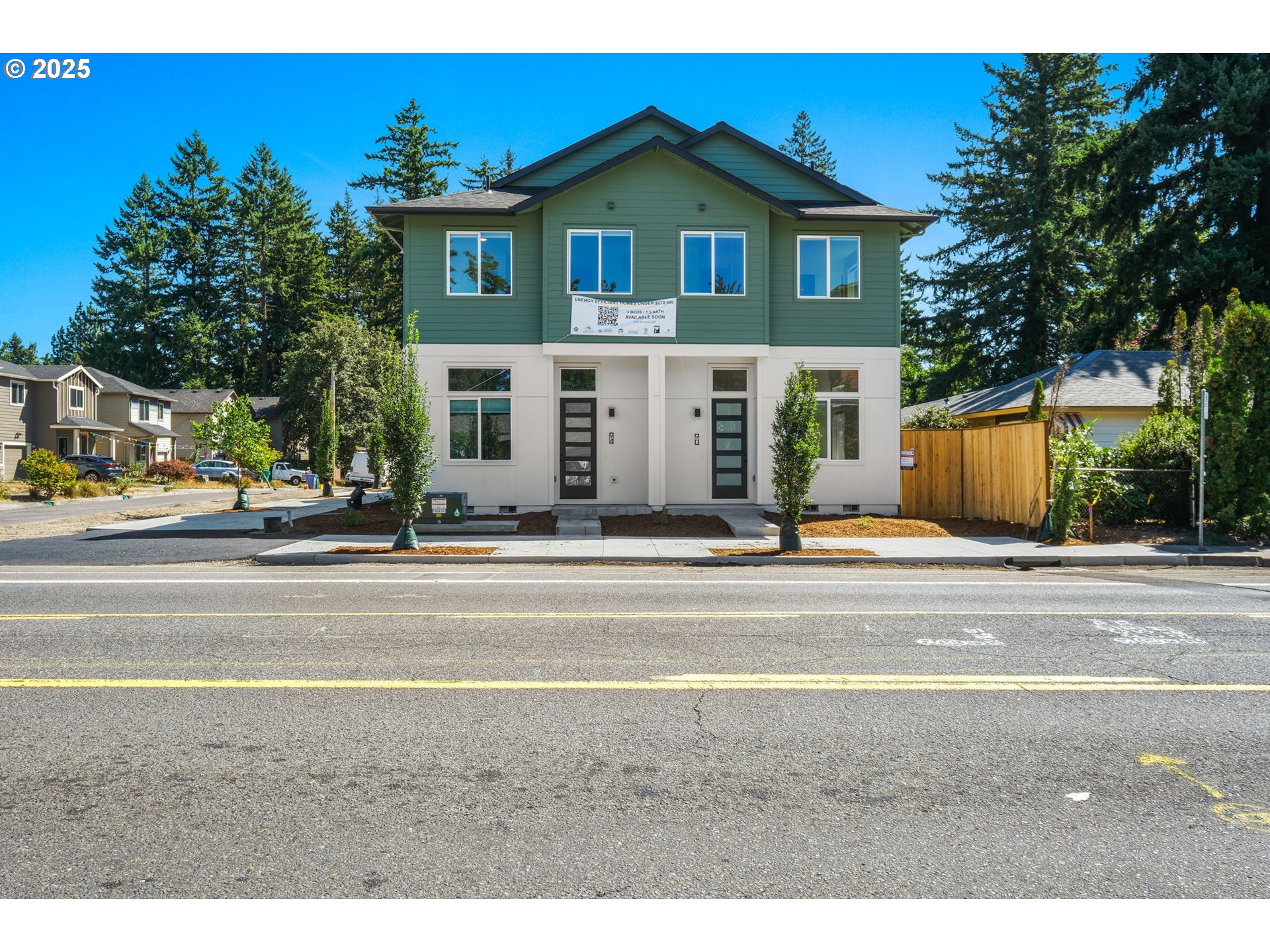 14852 Northeast Couch Street, Unit 9 Portland, OR 97230 - Photo 39 of 42 a view of a brick house with a clock tower in front of it
