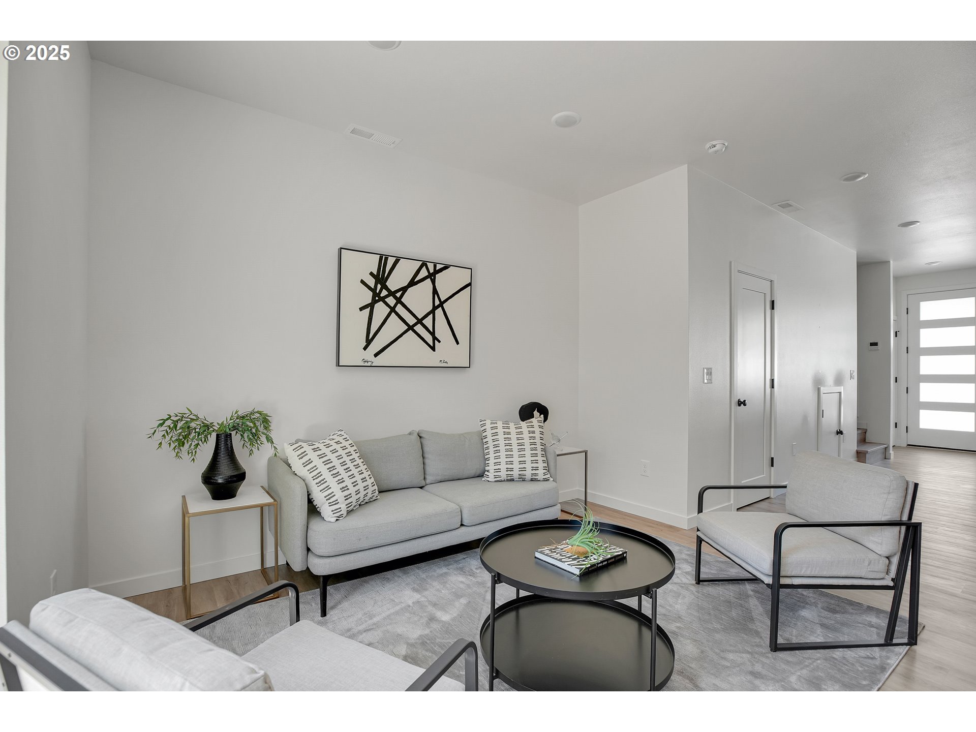 14852 Northeast Couch Street, Unit 9 Portland, OR 97230 - Photo 7 of 42 a living room with furniture a rug and a painting on the wall