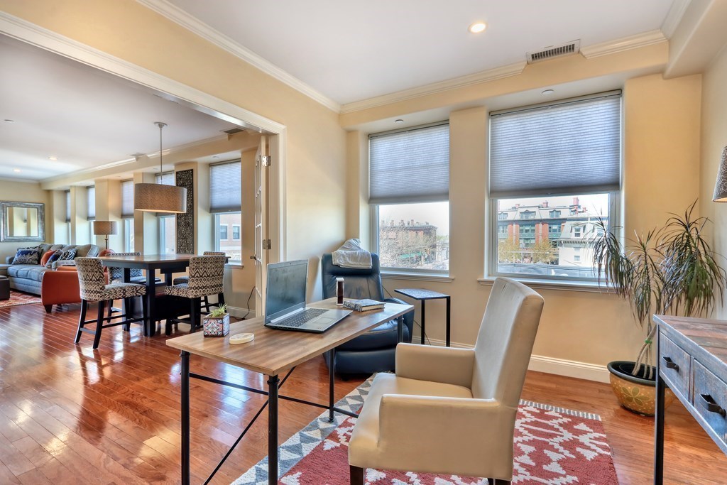 426 Main Street, Unit 402 Melrose, MA 02176 - Photo 12 of 24 a living room with furniture and floor to ceiling windows