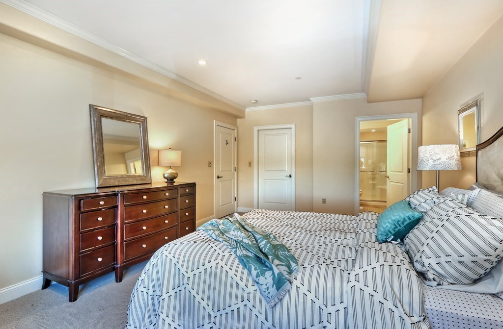 426 Main Street, Unit 402 Melrose, MA 02176 - Photo 15 of 24 a bedroom with a bed and a dresser