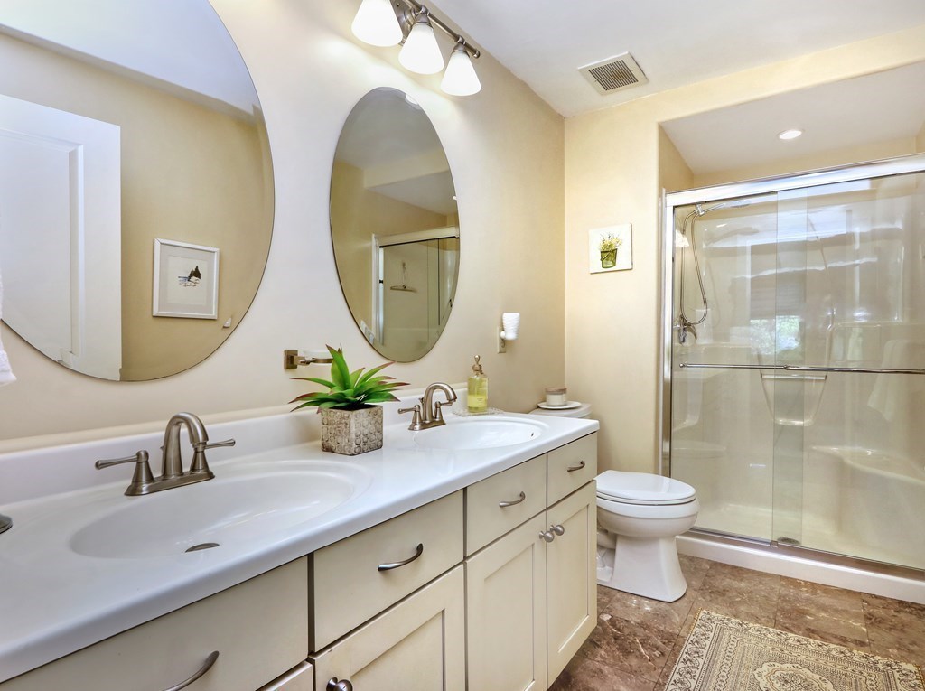 426 Main Street, Unit 402 Melrose, MA 02176 - Photo 16 of 24 a bathroom with a double vanity sink mirror and toilet