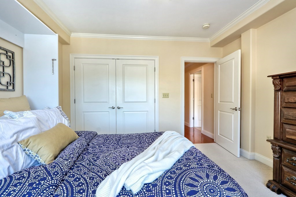 426 Main Street, Unit 402 Melrose, MA 02176 - Photo 19 of 24 a bedroom with a bed and a flat screen tv