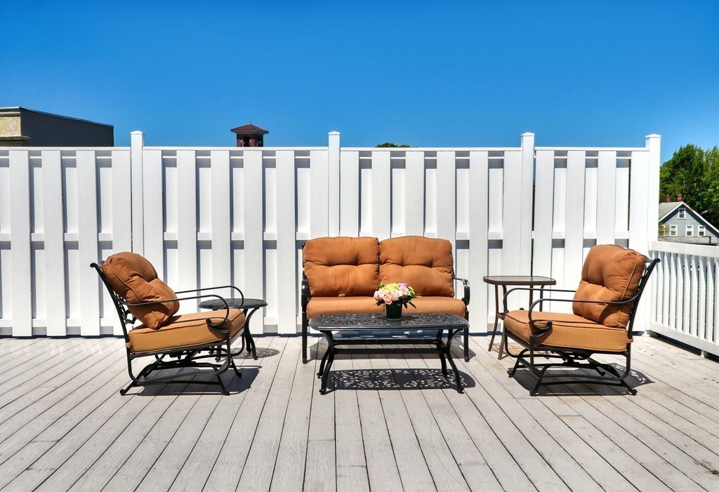 426 Main Street, Unit 402 Melrose, MA 02176 - Photo 20 of 24 a patio with patio a couch and wooden floor