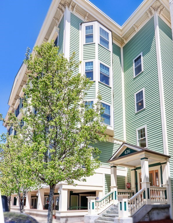 426 Main Street, Unit 402 Melrose, MA 02176 - Photo 23 of 24 a front view of a building with a garden