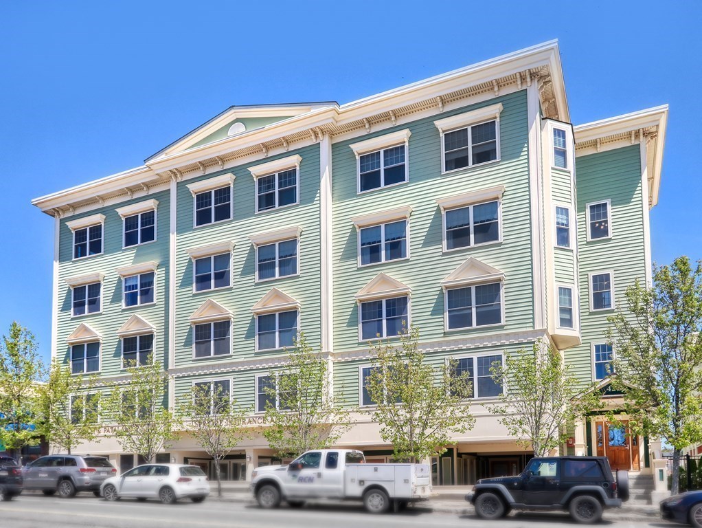 426 Main Street, Unit 402 Melrose, MA 02176 - Photo 24 of 24 a front view of a residential apartment building with cars parked