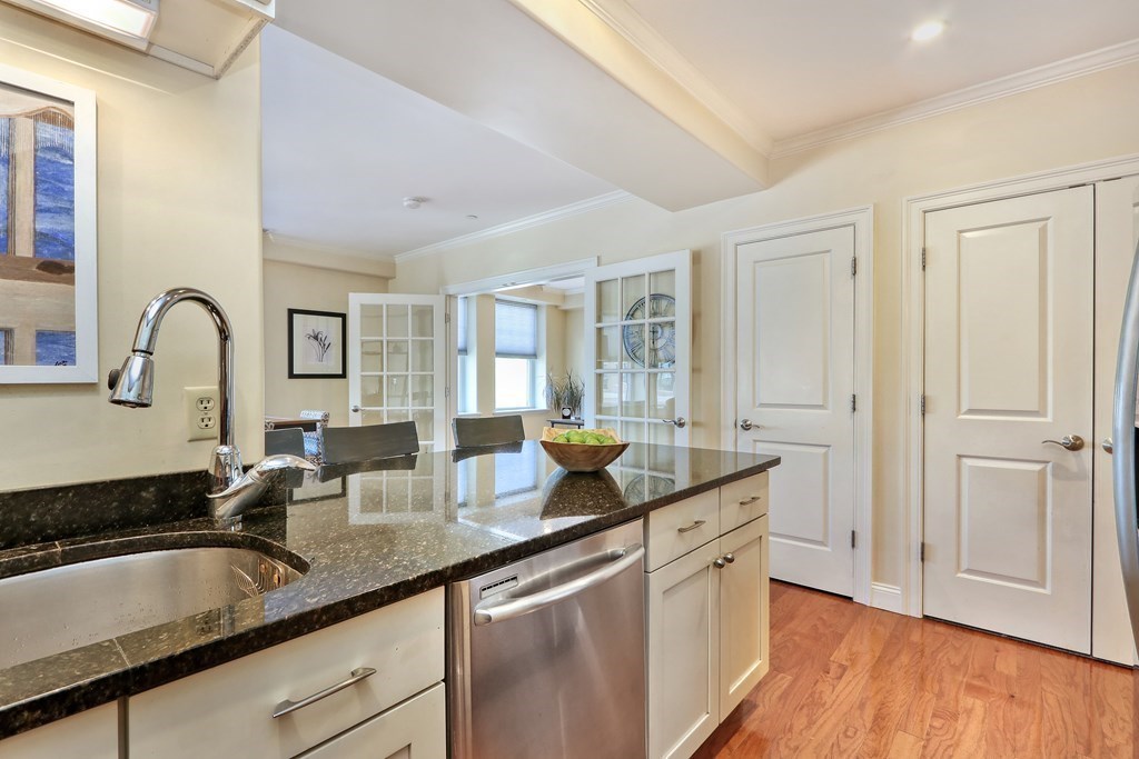 426 Main Street, Unit 402 Melrose, MA 02176 - Photo 6 of 24 a kitchen with granite countertop a sink and cabinets