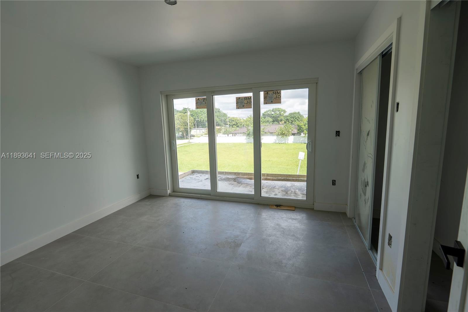 10290 Southwest 174th Terrace Miami, FL 33157 - Photo 12 of 15 a view of an empty room with glass door