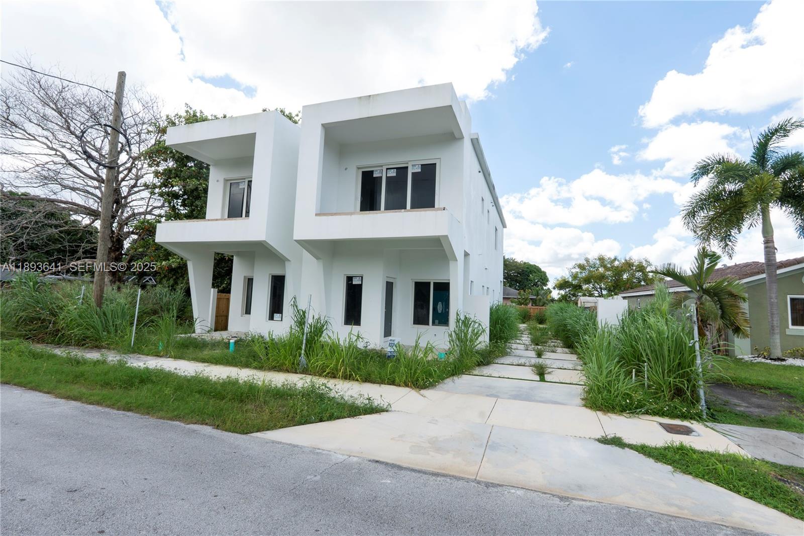 10290 Southwest 174th Terrace Miami, FL 33157 - Photo 2 of 15 a front view of house with yard and green space