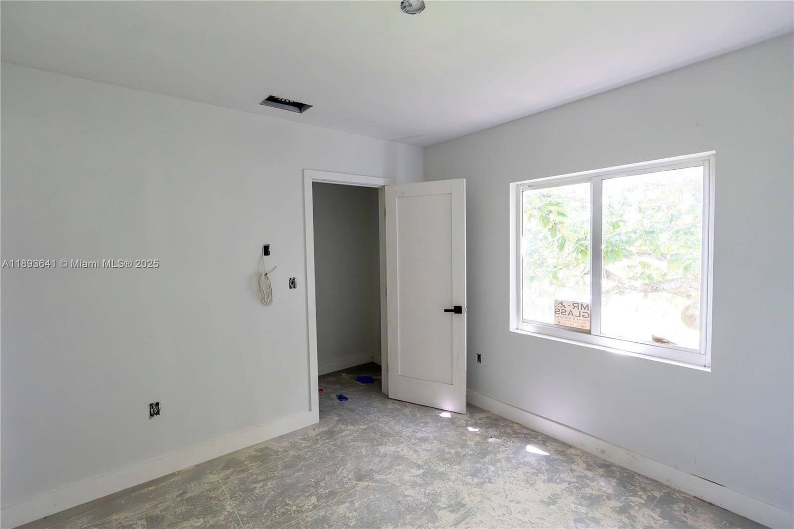 10290 Southwest 174th Terrace Miami, FL 33157 - Photo 5 of 15 a view of an empty room with a window