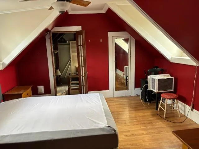 a bedroom with a bed and a window