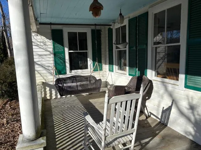a view of a patio with table and chairs and potted plants