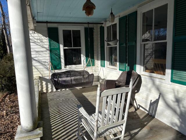 19 Monument Road Orleans, MA 02653 - Photo 2 of 20 a view of a patio with table and chairs and potted plants