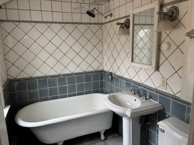 19 Monument Road Orleans, MA 02653 - Photo 9 of 20 a bathroom with a sink and a bathtub