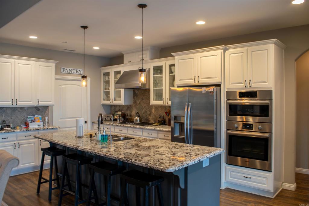 2521 Ralls Street Fallbrook, CA 92028 - Photo 9 of 43 a kitchen with stainless steel appliances granite countertop a sink refrigerator and cabinets