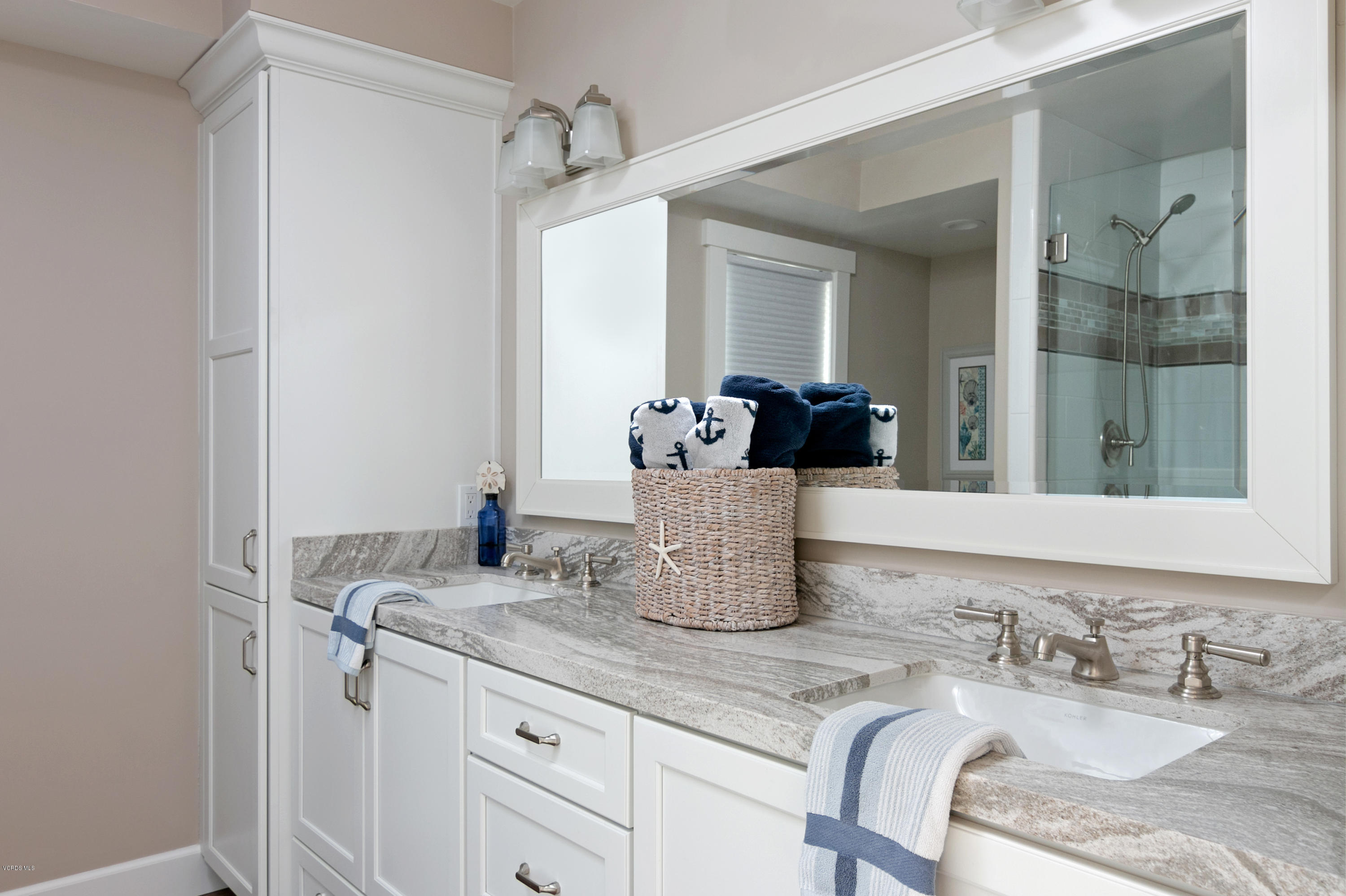 935 Mandalay Beach Road Oxnard, CA 93035 - Photo 47 of 67 a bathroom with a granite countertop sink and a mirror