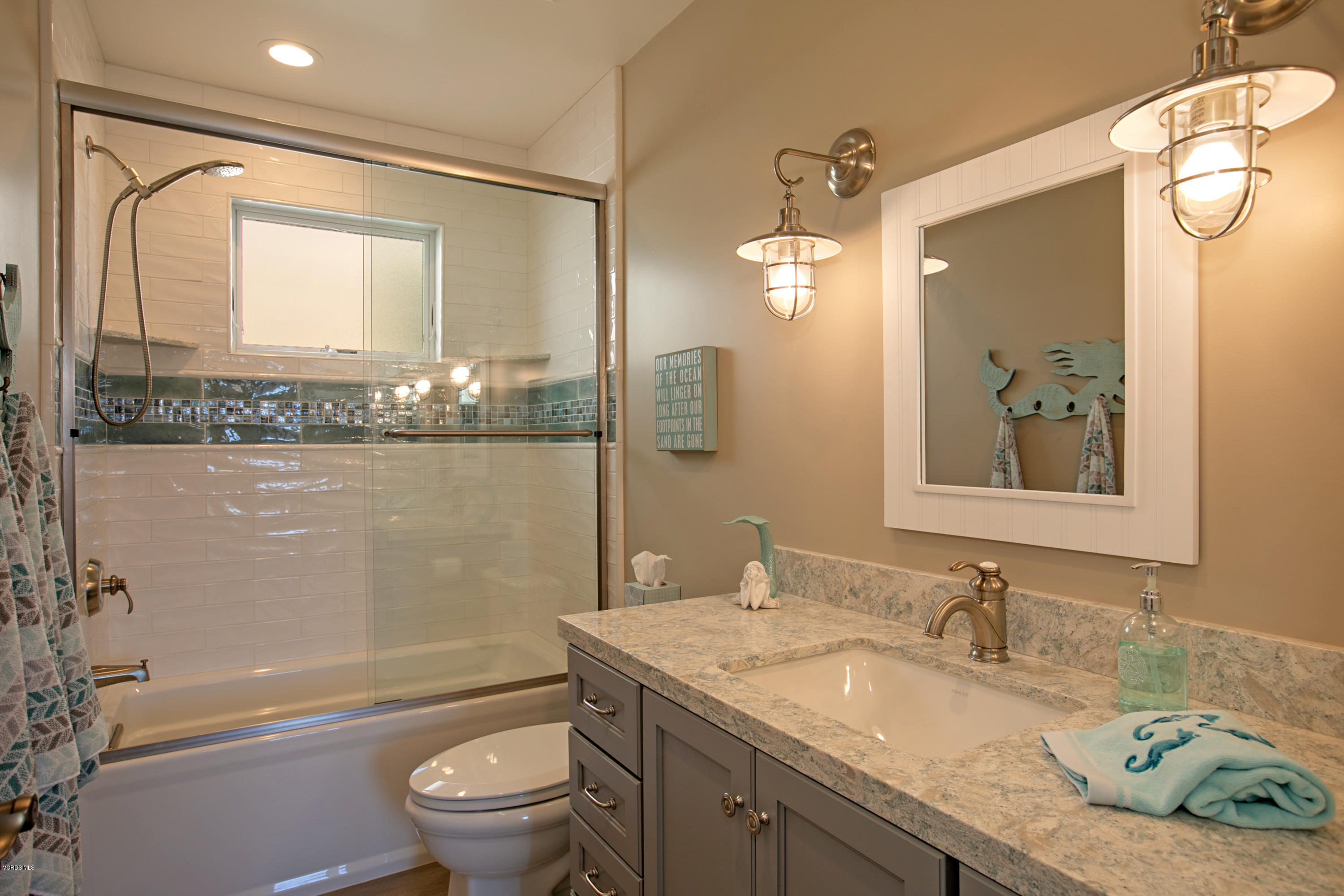 935 Mandalay Beach Road Oxnard, CA 93035 - Photo 51 of 67 a bathroom with a granite countertop sink a toilet and a mirror