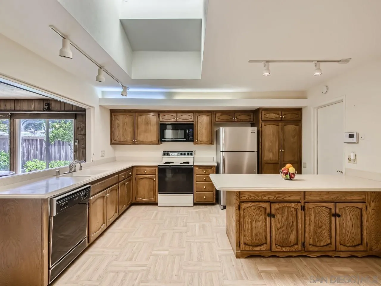 16319 Gabarda Road San Diego, CA 92128 - Photo 7 of 30 a kitchen with a stove a refrigerator and a microwave