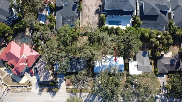 an aerial view of house with yard and sign board