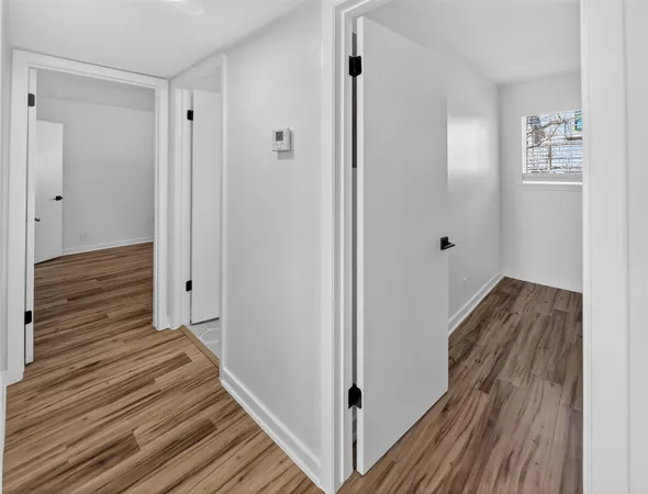 a view of a room with wooden floor and window