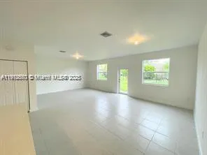 a kitchen with stainless steel appliances a stove a sink a refrigerator and a refrigerator