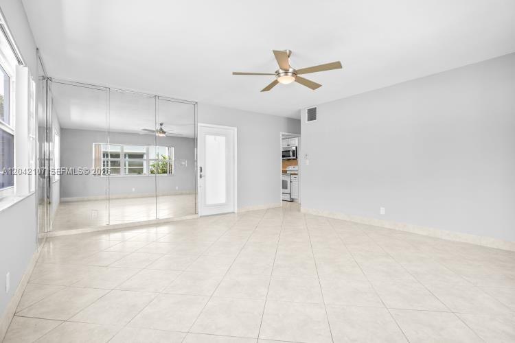 3213 Colony Club Road, Unit 3E Pompano Beach, FL 33062 - Photo 10 of 31 a view of an empty room with a window